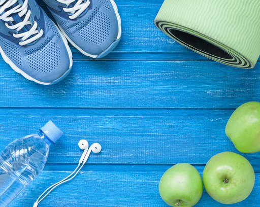 flat lay sport shoes bottle of water mat and earphones